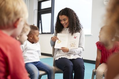 female-teacher-showing-a-book-to-kindergarten-children.jpg